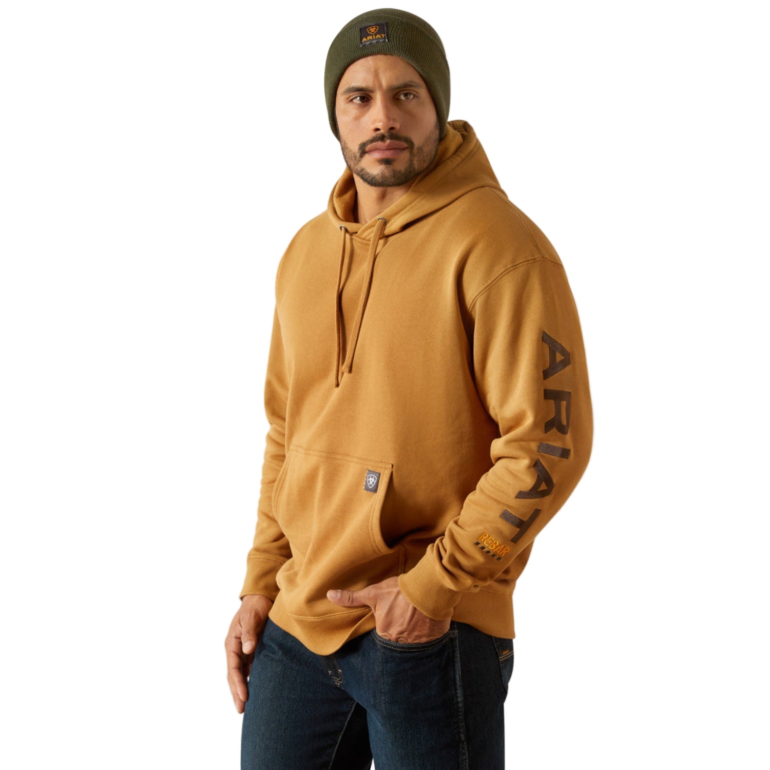 Man wearing a mustard yellow hoodie with 'AriaT' branding on a beige background